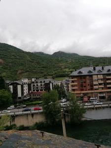 a city with buildings and a parking lot with cars at APARTAMENT BETTY in Sort +18 photos