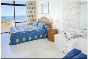 Postel nebo postele na pokoji v ubytování Anfi del Mar - Apartament mit Meerblick