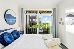 a bedroom with a large bed with a large window at 3 Bedroom Stunner in Hobsonville - WiFi - Netflix in Auckland