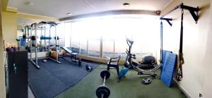 a gym with several treadmills and exercise bikes at Departamento equipado (santiago) in Santiago