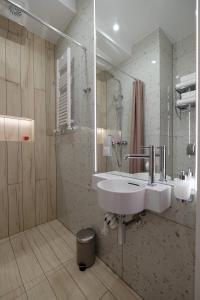 a bathroom with a white sink and a shower at Apartamenty Centrum in Białystok +141 photos