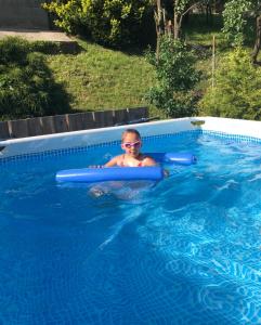 a young child in a pool in a swimming pool at Na Świerkowym Strychu in Szczawnica