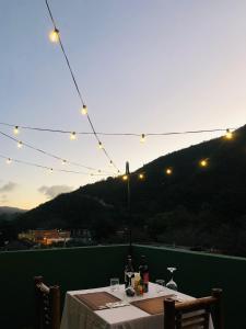 a table with lights on a balcony with a mountain at Loma Alta Hotel Boutique in Polo