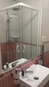 a bathroom with a sink and a mirror at El pisito de Malasaña in Madrid