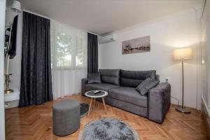 a living room with a couch and a table at Apartment PEACE in Trebinje