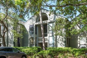 a house with a car parked in front of it at 1305 Pelican Watch Villa in Seabrook Island