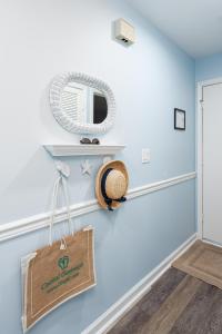 a room with a blue wall with a mirror and a bag at 1305 Pelican Watch Villa in Seabrook Island