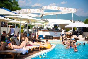 a group of people sitting in a swimming pool at Mai Tai Resort in Tirana