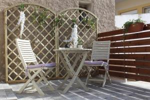 two chairs and a table on a patio at inHeart Apartment Chios in Chios