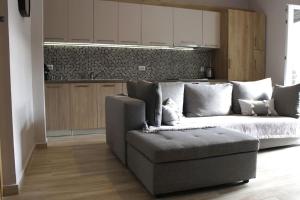 a living room with a couch and a kitchen at inHeart Apartment Chios in Chios