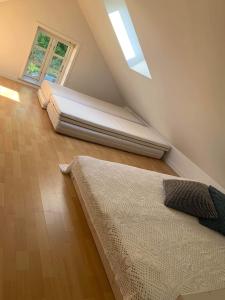 a attic bedroom with a bed and a window at Hærvejshuset 