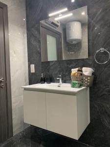 a bathroom with a white sink and a mirror at Spacious lovely apartment in Mġarr 1 in Mġarr