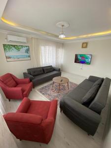 a living room with two couches and a table at Misho Apart in Trabzon