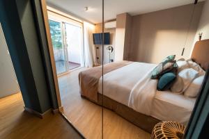 a bedroom with a large bed and a mirror at Hotel Taburiente S.C.Tenerife in Santa Cruz de Tenerife
