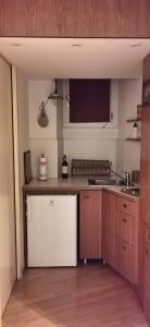 a kitchen with a white refrigerator and a sink at Cenacolo Apartment in Milan