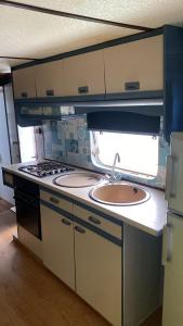 a kitchen with a sink and a stove at Relax in pasito blanco camping house in Maspalomas