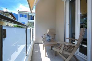 a balcony with two chairs and a table on it at Kallithea Guesthouse in Nydri