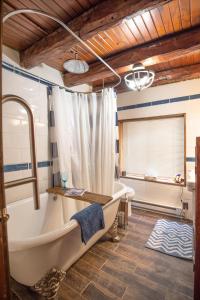 a large bathroom with a tub and a window at Blue Moon Log Cabin in Nashville