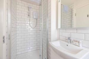 a white bathroom with a sink and a shower at Charming 3Bed 3Bath Home in Windsor with parking! in Windsor +24 photos