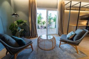 a living room with two chairs and a table at Hotel Taburiente S.C.Tenerife in Santa Cruz de Tenerife
