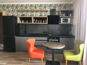 a kitchen with a table and two chairs and a table at Dream Apartament in Morshin