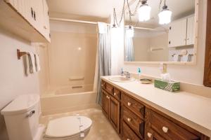 a bathroom with a toilet and a sink and a tub at Sugar Cottage in Nashville +25 photos