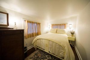 a bedroom with a bed and a dresser and window at 1840 Stagecoach in Nashville