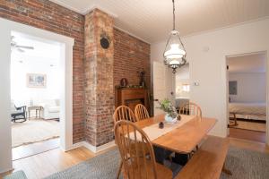 a dining room with a brick wall and a wooden table at 1840 Stagecoach in Nashville