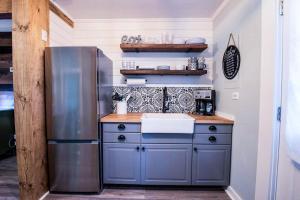 a kitchen with a stainless steel refrigerator and a sink at Brown County Cottage in Nashville