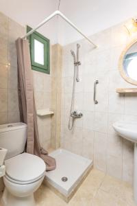 a bathroom with a toilet and a shower and a sink at D&G Apartments in Agia Paraskevi
