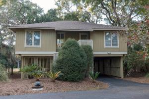 a brown house with a driveway in front of it at 1135 Summerwind Cottage in Seabrook Island