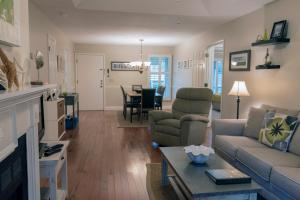 a living room with a couch and a table at 1135 Summerwind Cottage in Seabrook Island