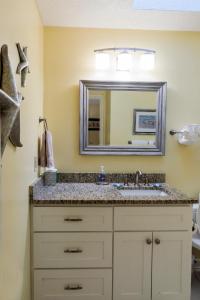 a bathroom with a sink and a mirror at 1135 Summerwind Cottage in Seabrook Island +28 photos