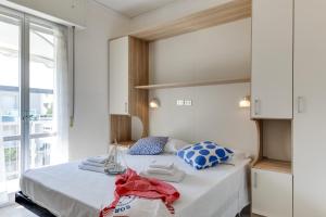 a bedroom with a bed with towels on it at B&B Villa Madana in Rimini