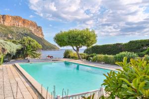 a swimming pool with a view of the ocean at Le Canaillou par Dodo-a-Cassis in Cassis