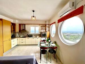 a kitchen with a table and chairs and a window at Ocean view Apartment in Rhodes Town