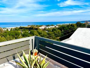 a view of the ocean from a balcony with a plant at Ocean view Apartment in Rhodes Town