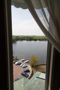 a view of a large lake from a window at Hotel & Restaurant Infinity in Lichtmis