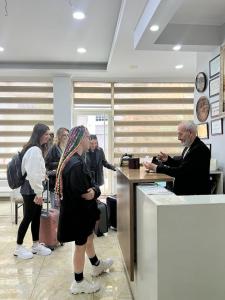 a group of people waiting at a counter in an office at Reydel Hotel in Istanbul