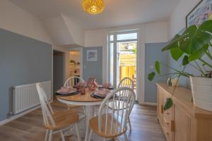 a dining room with a table and chairs at Delightful Blue Shells Cottage - 2bedrooms -Garden - 5mins beach - 1min Shell Grotto in Kent