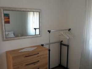 a bedroom with a dresser and a mirror on the wall at Frka Petešić in Sali