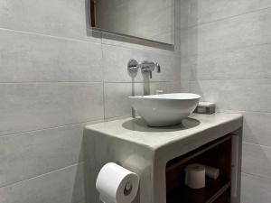 a bathroom with a bowl sink on a counter at Niabelo Villa in Kamari