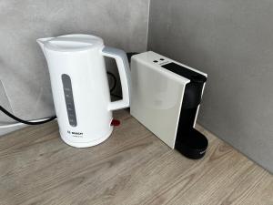 a white appliance next to a toaster and a blender at Niabelo Villa in Kamari