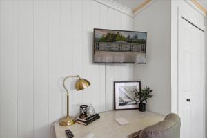 a desk with a lamp and a picture on the wall at Lake Front home 5Min to DTPetoskey W D Fireplace King in Petoskey