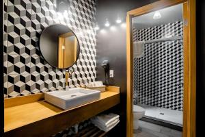 a bathroom with a sink and a mirror at The Studios 22800 in Ensenada