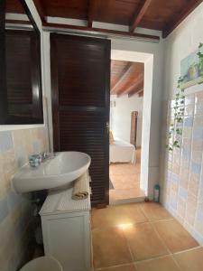 a bathroom with a sink and a bathroom with a bedroom at HAPPY HOUSE NANE in Playa Honda