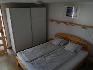 a bedroom with a bed with a wooden headboard at Lázár Apartman in Balatonlelle