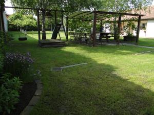 a yard with a picnic table and a gazebo at Lázár Apartman in Balatonlelle