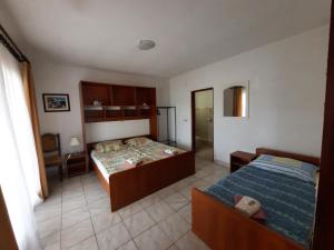 Postel nebo postele na pokoji v ubytování Apartments Dario