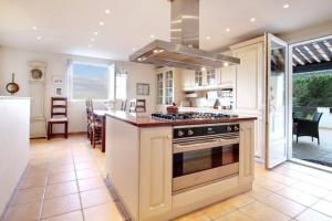 a kitchen with an island with a stove top oven at South of France Villa in Carros